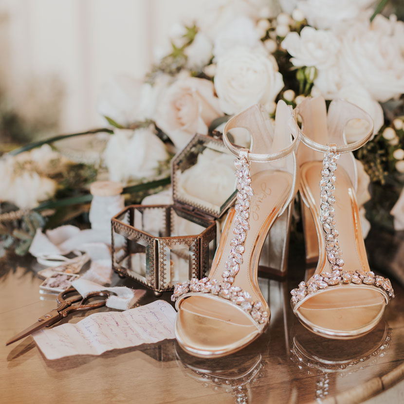heels with white rose bouquet in background